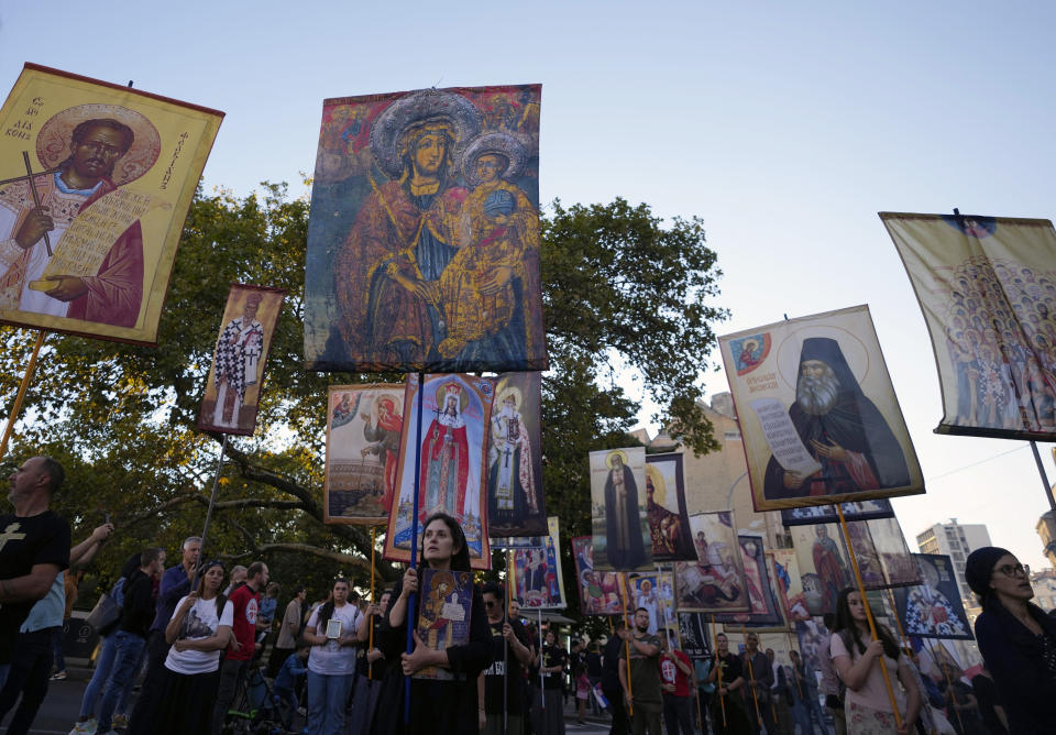 FILE - People hold icons and march during a protest against the international LGBT event Euro Pride in Belgrade, Serbia, Sunday, Sept. 11, 2022. Serbia's police on Tuesday banned an international Pride march that is to be held later this week, citing a risk of clashes between gay rights activists and far-right opponents of a pan-European LGBTQ events planned for this week in Belgrade. (AP Photo/Darko Vojinovic, File)