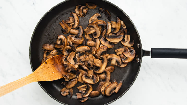 Mushrooms frying in pan