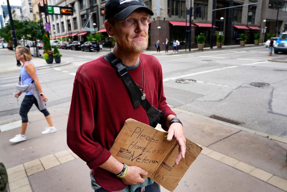 Downtown residents, homeless advocates and health experts alike told The Enquirer the public shouldn't give money to people panhandling. Shown here: Odis, 44, a war veteran. While he flys a sign on Fourth Street, he doesn't directly ask people for money.