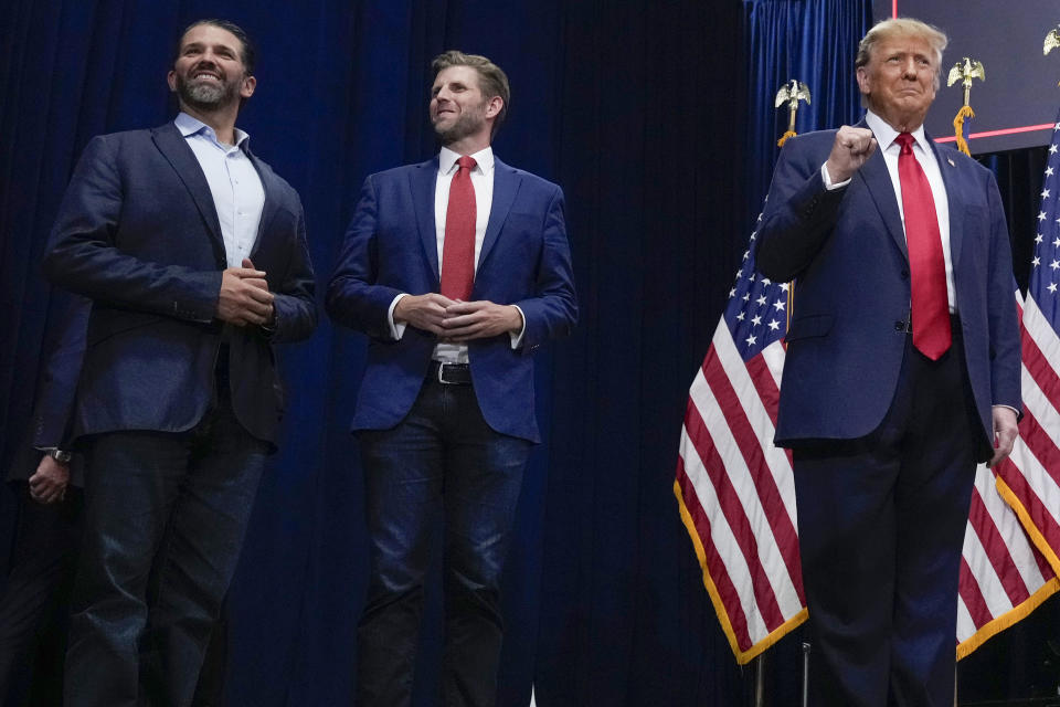 FILE - Republican presidential candidate former President Donald Trump arrives with his sons Donald Trump, Jr., left and Eric Trump, to speak at a caucus night party in Des Moines, Iowa, Jan. 15, 2024. A New York judge ruled Friday, Feb. 16, 2024, against Donald Trump, imposing a $364 million penalty over what the judge ruled was a yearslong scheme to dupe banks and others with financial statements that inflated the former president's wealth. (AP Photo/Andrew Harnik, File)