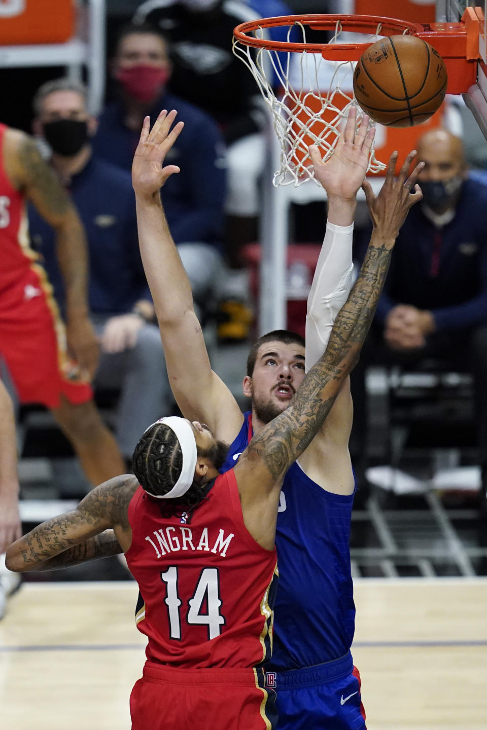 Los Angeles Clippers center Ivica Zubac, rear, defends against New Orleans Pelicans forward Brandon Ingram (14) during the second quarter of an NBA basketball game Wednesday, Jan. 13, 2021, in Los Angeles. (AP Photo/Ashley Landis)