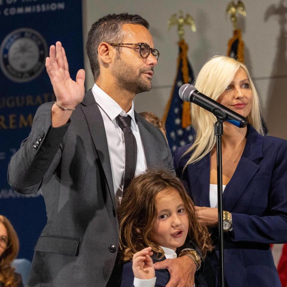 Commissioner David Suarez, left, is sworn into office with his family by his side during a swearing-in ceremony at the Miami Beach Convention Center on November 28, 2023.