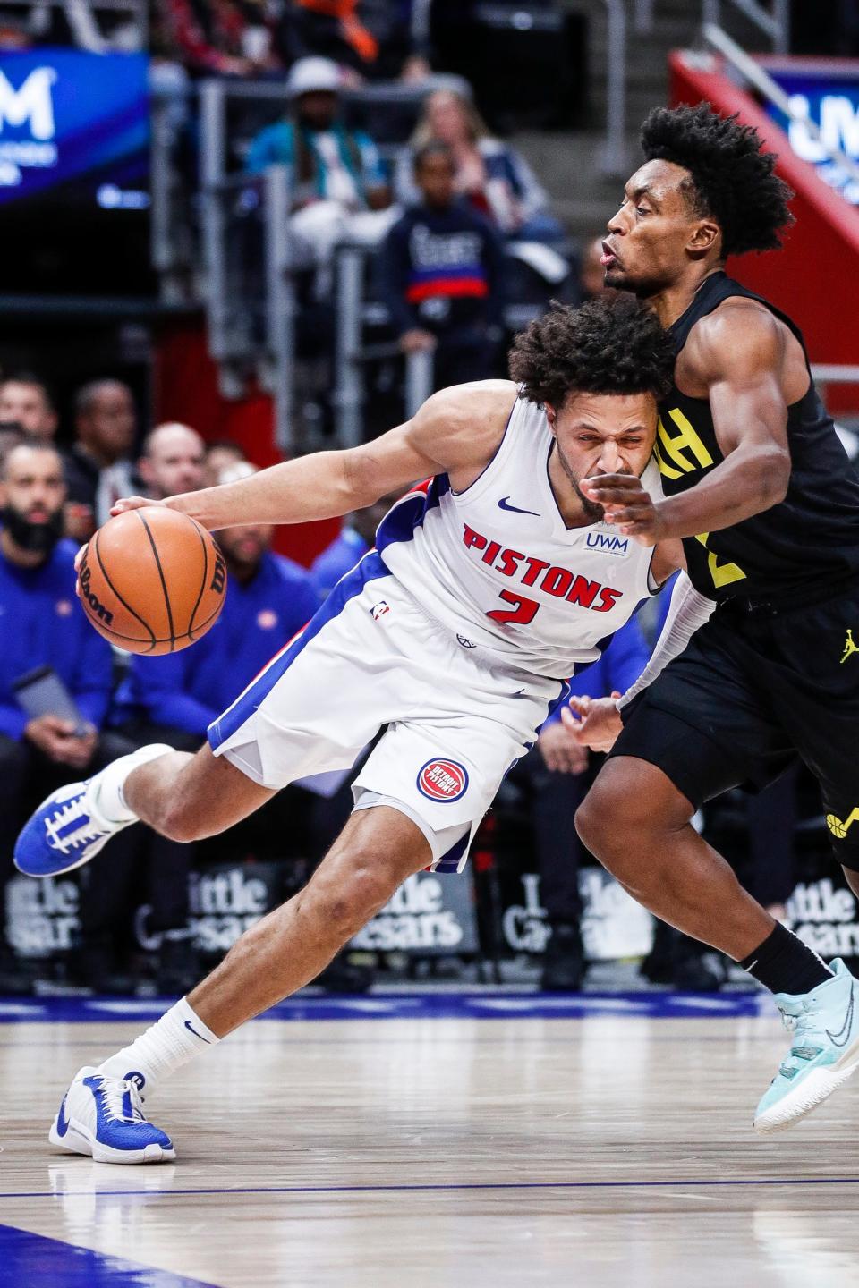 Detroit Pistons guard Cade Cunningham dribbles against Utah Jazz guard Collin Sexton during the second half at Little Caesars Arena in Detroit on Thursday, Dec. 21, 2023.