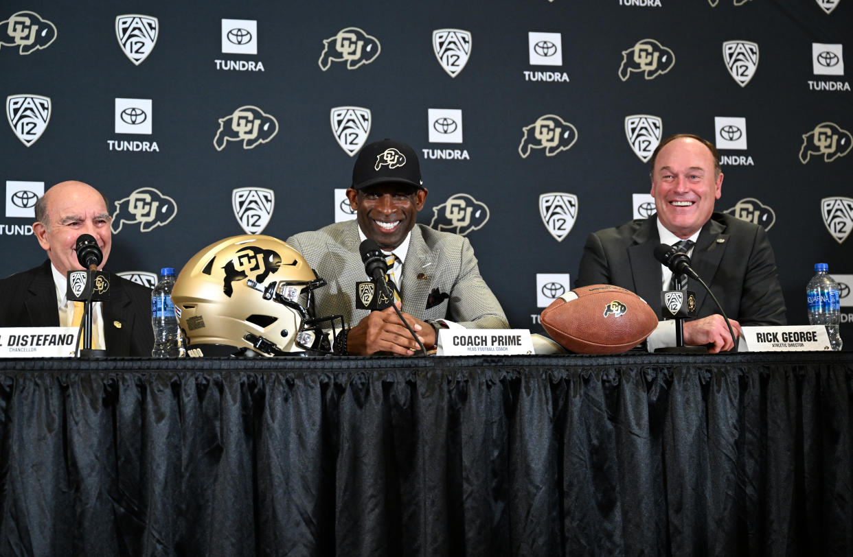 Deion Sanders is announced as Colorado's new head football coach alongside Phil DiStefano (L) and athletic director Rick George on Dec. 4. (Helen H. Richardson/MediaNews Group/The Denver Post via Getty Images)