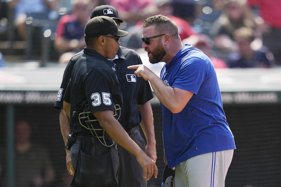 Toronto Blue Jays manager John Schneider, right, continues to argue with home plate umpire Jeremie Rehak (35) after being ejected from the game in the seventh inning of a baseball game against the Cleveland Guardians, Thursday, Aug. 10, 2023, in Cleveland. (AP Photo/Sue Ogrocki)