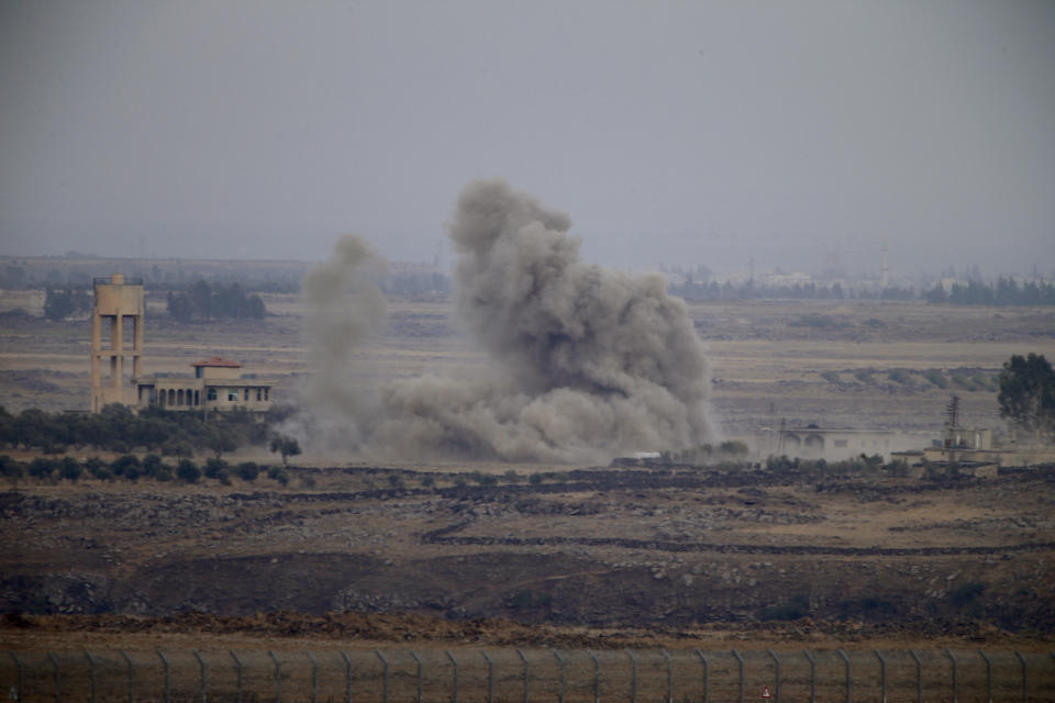 Smoke and explosions from the fighting between forces loyal to Syrian President Bashar Assad and rebels in southern Syria as seen from the Israeli-controlled Golan Heights, Wednesday, July 25, 2018. (AP Photo/Ariel Schalit)