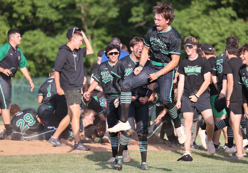 Mason players celebrate their victory in the regional championship game between Mason and Moeller high schools at Midland Field June 4, 2022.