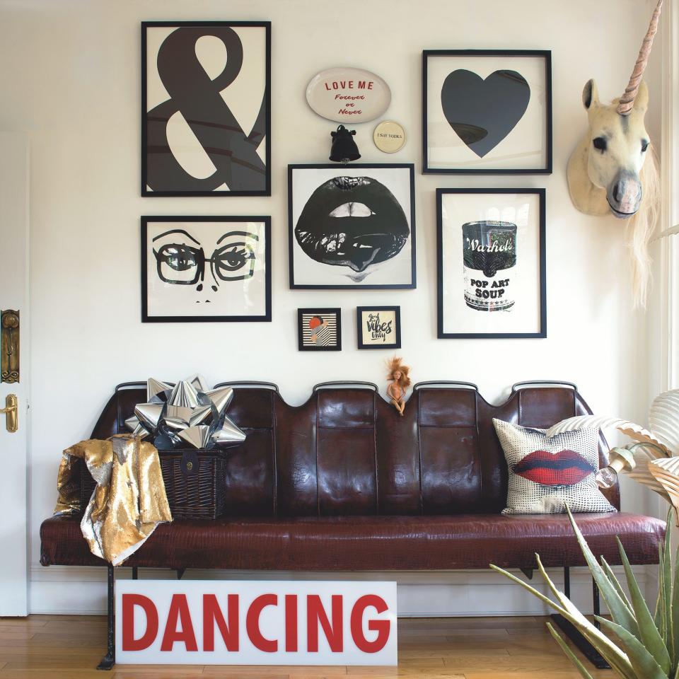 A row of antique leather seats taken from the back of an old bus and discovered by St George at the antiques fair in Ardingly is the perfect resting place for weary dancers. The dancing sign is from Rockett St George, as are the aloe plant and unicorn. St George’s love of pop art and graphic prints is on full display here. -  Claire Worthy