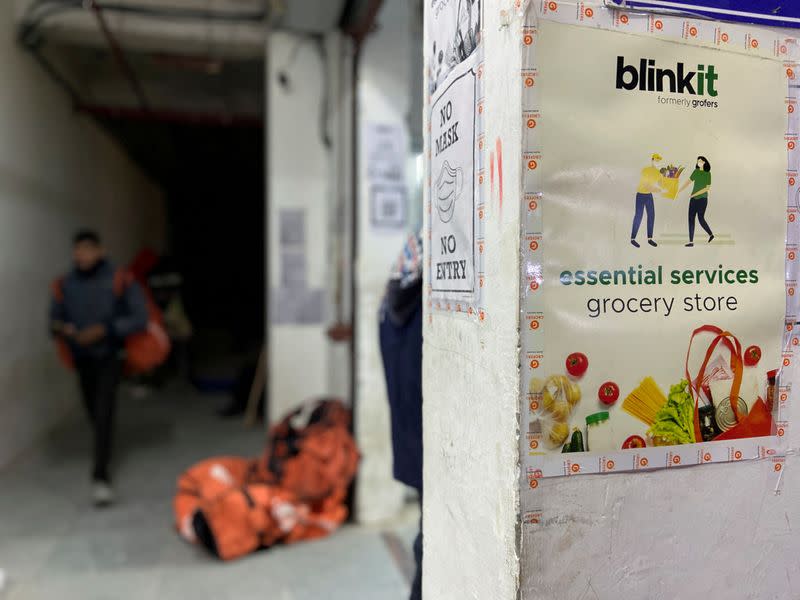 FILE PHOTO: A delivery person leaves a dark store of the SoftBank-funded Blinkit in New Delhi