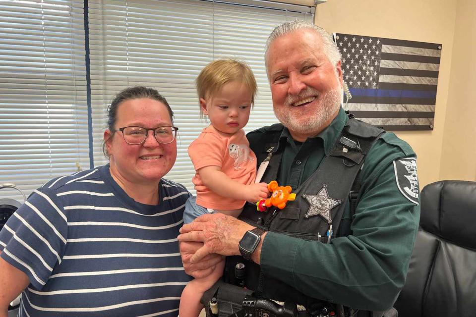 <p>LCSO</p> Deputy William Weaver with baby Cheyanne