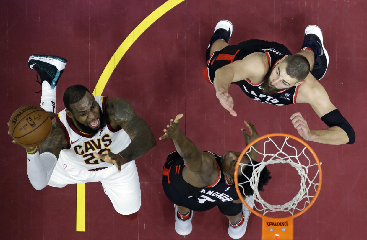 LeBron James attacks over OG Anunoby and Jonas Valanciunas. The Raptors are going to see this a lot over the next two weeks. (AP)