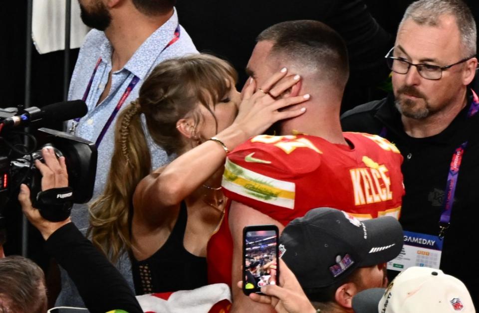 Taylor Swift kisses Travis Kelce after the Chiefs won Super Bowl LVIII against the San Francisco 49ers. AFP via Getty Images
