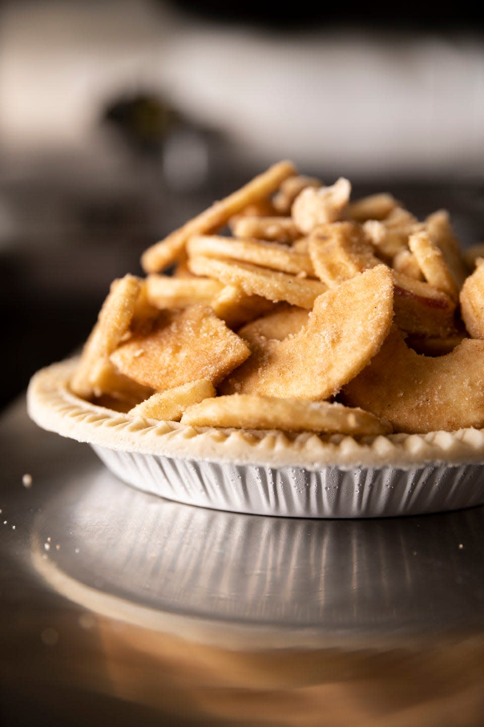 an unbaked pie piled high with apples from peck and bushel organic fruit co in erin, wisconsin