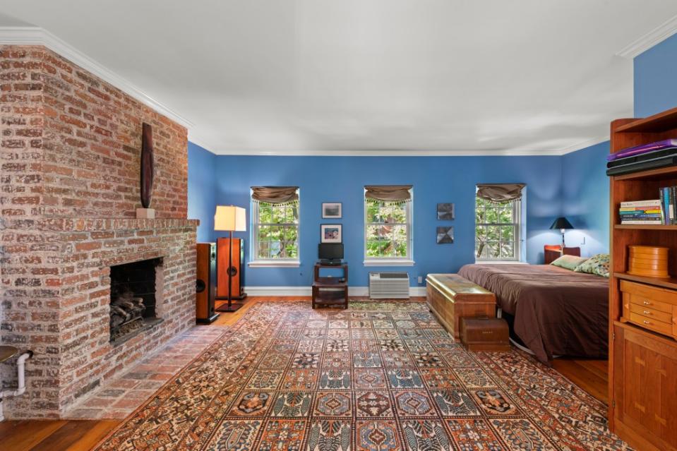 A brick fireplace in the main bedroom. Richard Caplan