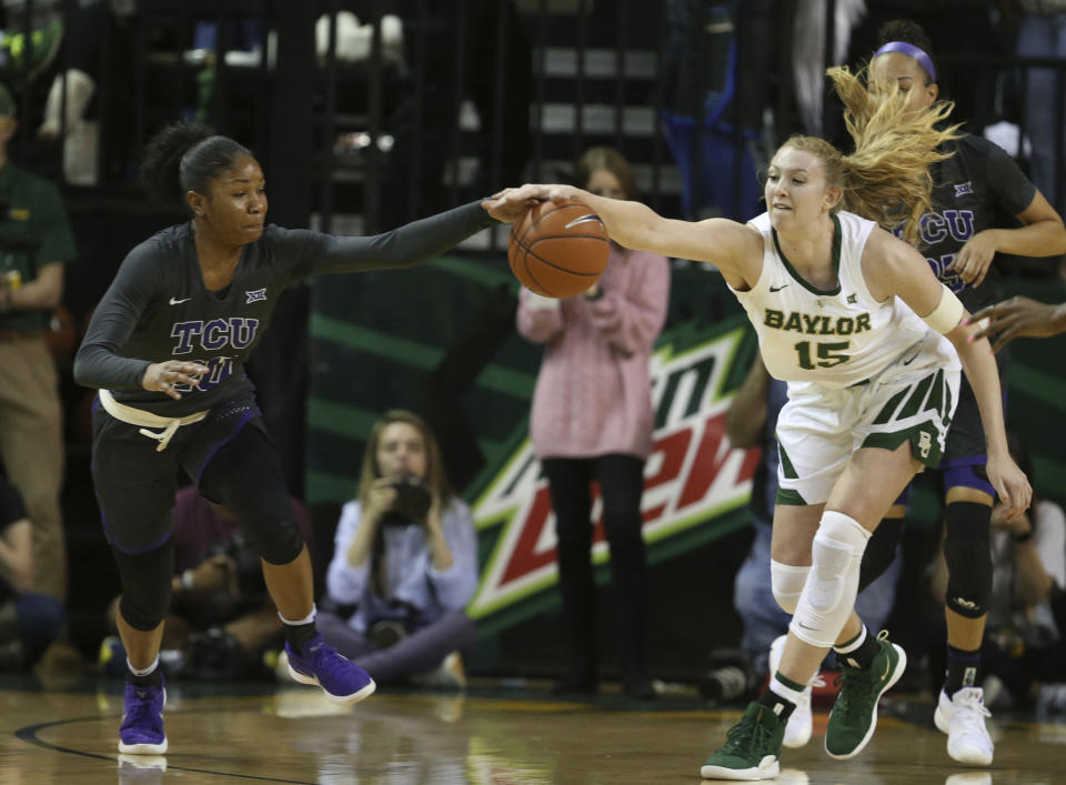 Baylor forward Lauren Cox, right, reaches for a loose ball with TCU guard Lauren Heard, left, in the first half of an NCAA college basketball game, Saturday, Feb. 9, 2019, in Waco, Texas. (AP Photo/Rod Aydelotte)