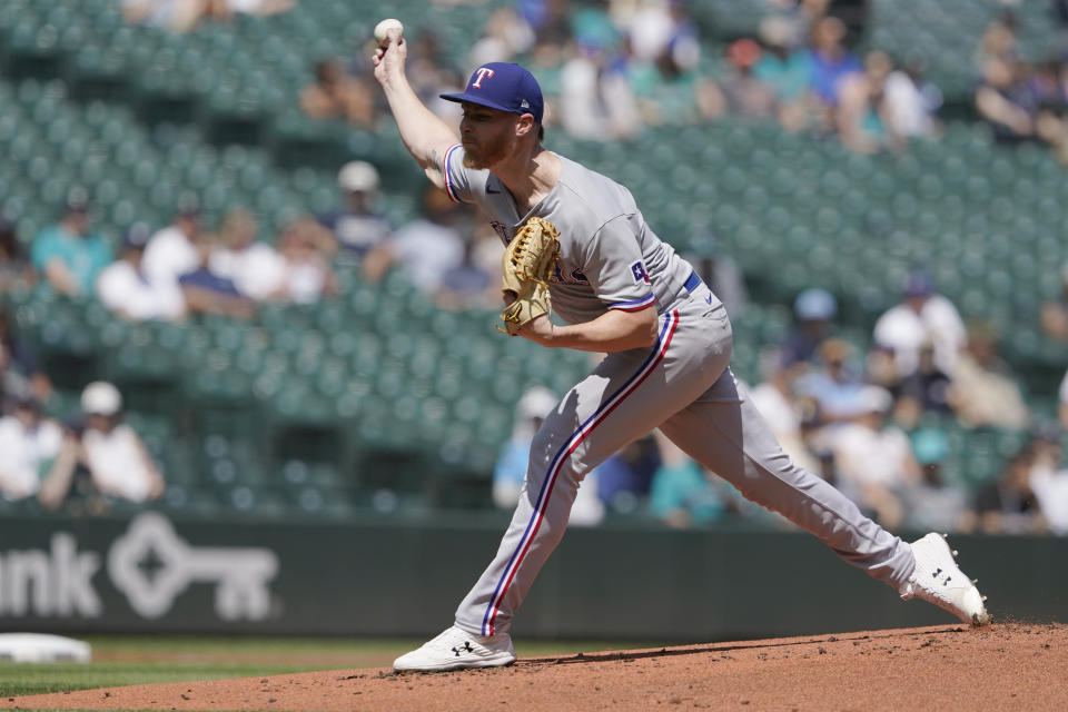 Texas Rangers starting pitcher Jon Gray throws against the Seattle Mariners during the first inning of a baseball game, Wednesday, July 27, 2022, in Seattle. (AP Photo/Ted S. Warren)