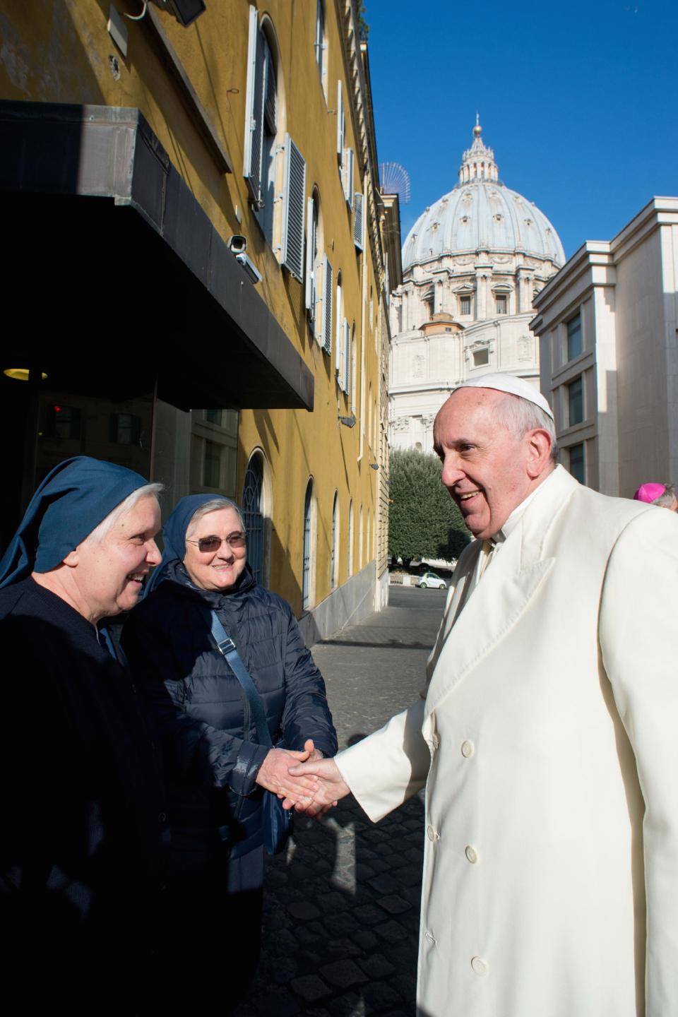 Pope Francis greets nuns after visiting the Pediatric Dispensary of Santa Marta at the Vatican