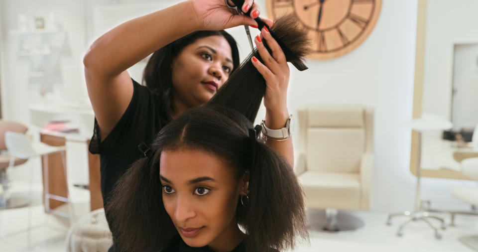 woman getting her hair cut in a salon