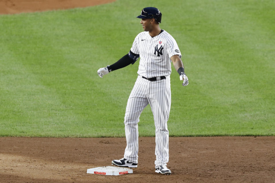 New York Yankees' Aaron Hicks smiles toward the dugout after hitting an RBI double during the second inning of the team's baseball game against the Boston Red Sox, Sunday, Aug. 16, 2020, in New York. (AP Photo/Kathy Willens)