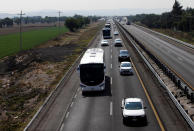 <p>Buses carrying Central American migrants, as part of a caravan moving through Mexico toward the U.S. border, drive on a highway in Puebla state, Mexico April 6, 2018. (Photo: Henry Romero/Reuters) </p>