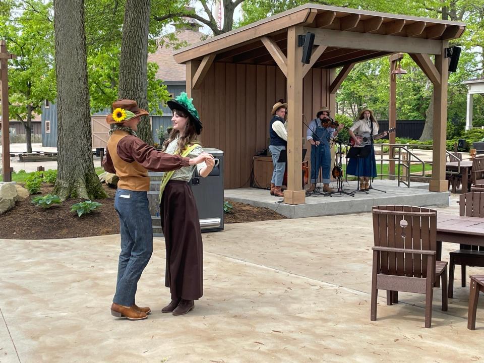 Cedar Point actors dance to live music during the park's Frontier Festival.