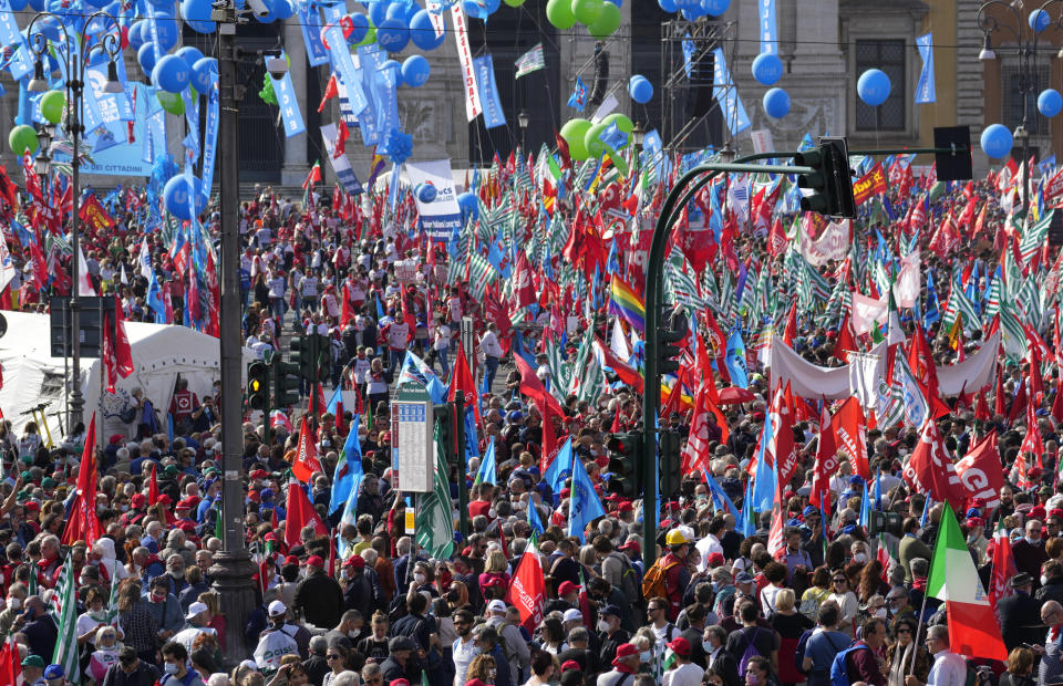 Demonstrators take part in a march organized by Italy's main labor unions, in Rome's St. John Lateran square, Saturday, Oct. 16, 2021. The march was called a week after protesters, armed with sticks and metal bars, smashed their way into the headquarters of CGIL, a left-leaning union, and trashed its office, during a demonstration to protest a government rule requiring COVID-19 vaccines or negative tests for workers to enter their offices. (AP Photo/Andrew Medichini)