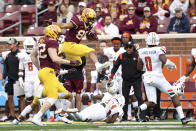 Minnesota tight end Brevyn Spann-Ford (88) leaps over Bowling Green cornerback Marcus Sheppard (21) during an NCAA college football game Saturday, Sept. 25, 2021, in Minneapolis. (AP Photo/Stacy Bengs)