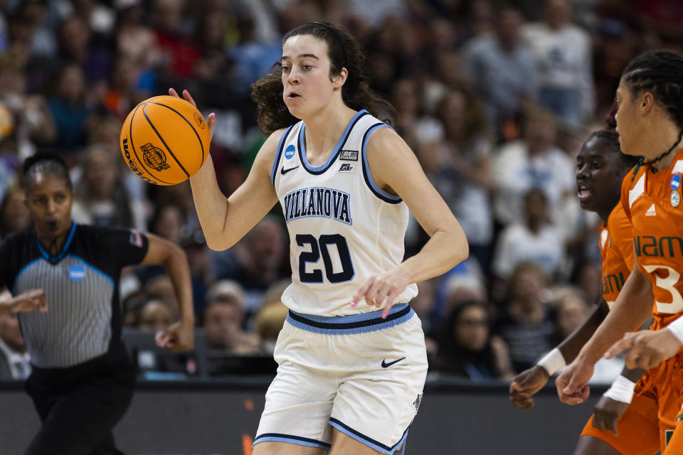 Villanova's Maddy Siegrist (20) drives to the basket against Miami's Destiny Harden (3) in the first half of a Sweet 16 college basketball game of the NCAA Tournament in Greenville, S.C., Friday, March 24, 2023. (AP Photo/Mic Smith)