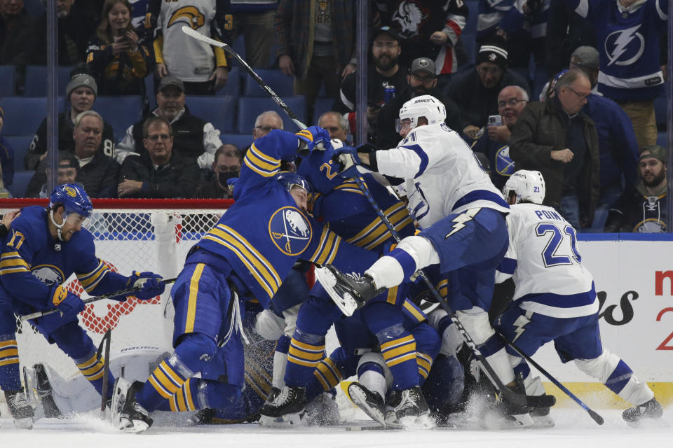Buffalo Sabres and Tampa Bay Lightning players fight during the third period of an NHL hockey game Monday, Nov. 28, 2022, in Buffalo, N.Y. (AP Photo/Joshua Bessex)