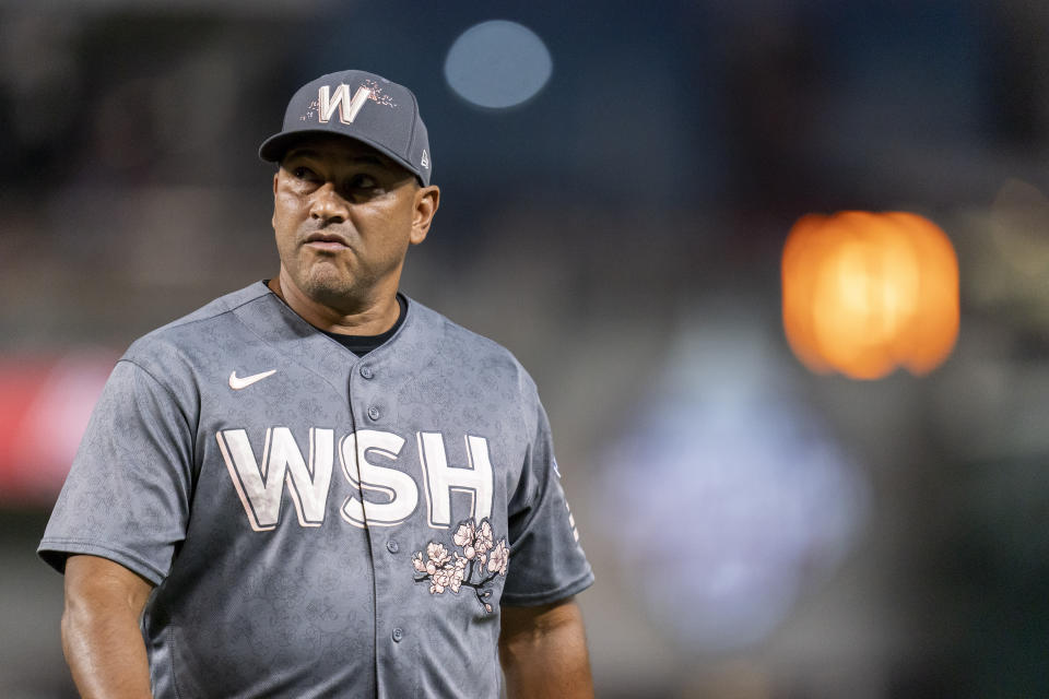 Washington Nationals manager Dave Martinez returns to the dugout after a mound visit to make a pitching substitution during the sixth inning of a baseball game against the Los Angeles Dodgers, Friday, Sept. 8, 2023, in Washington. (AP Photo/Stephanie Scarbrough)