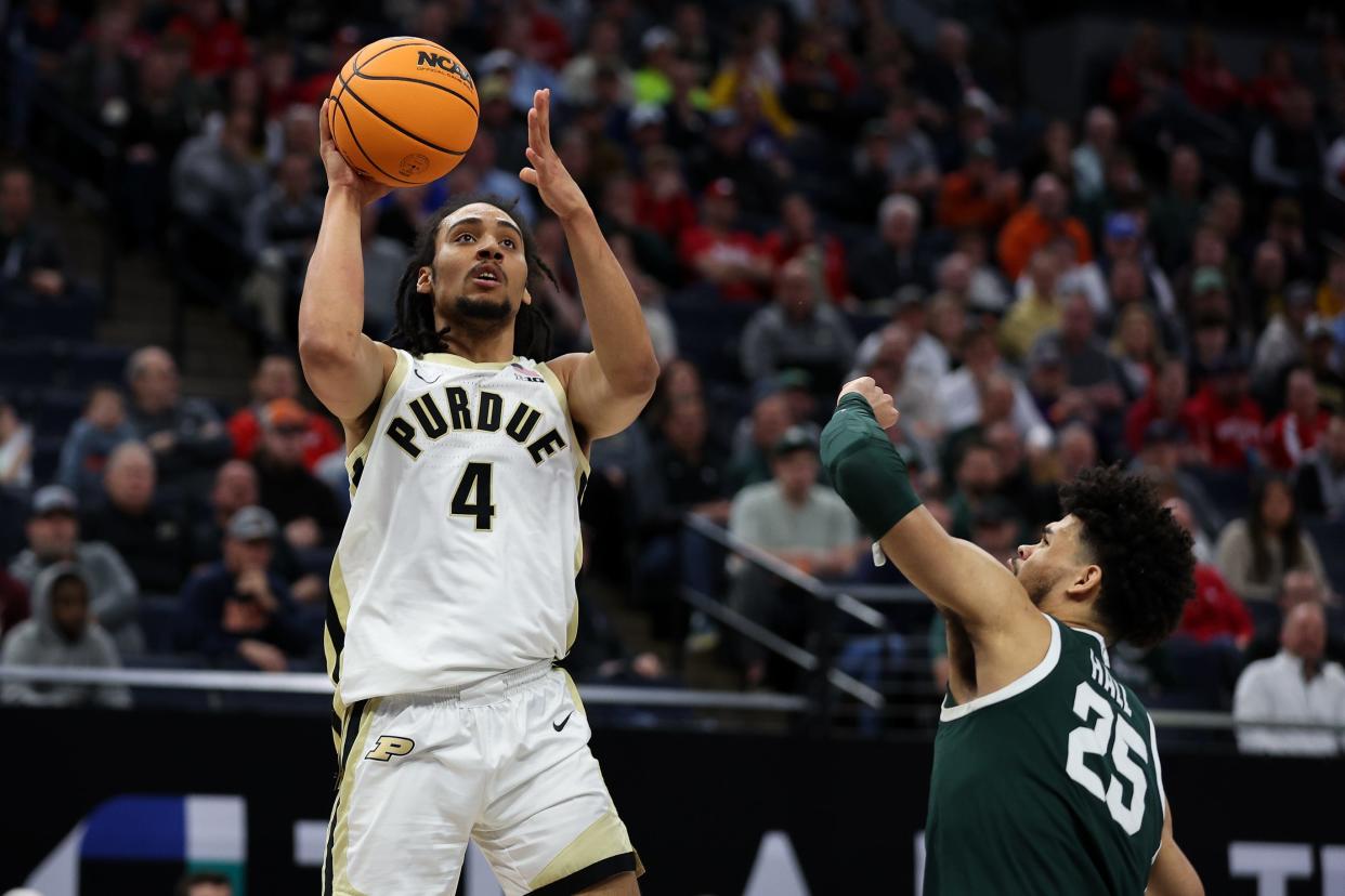 Mar 15, 2024; Minneapolis, MN, USA; Purdue Boilermakers forward Trey Kaufman-Renn (4) shoots as Michigan State Spartans forward Malik Hall (25) defends during the first half at Target Center. Mandatory Credit: Matt Krohn-USA TODAY Sports