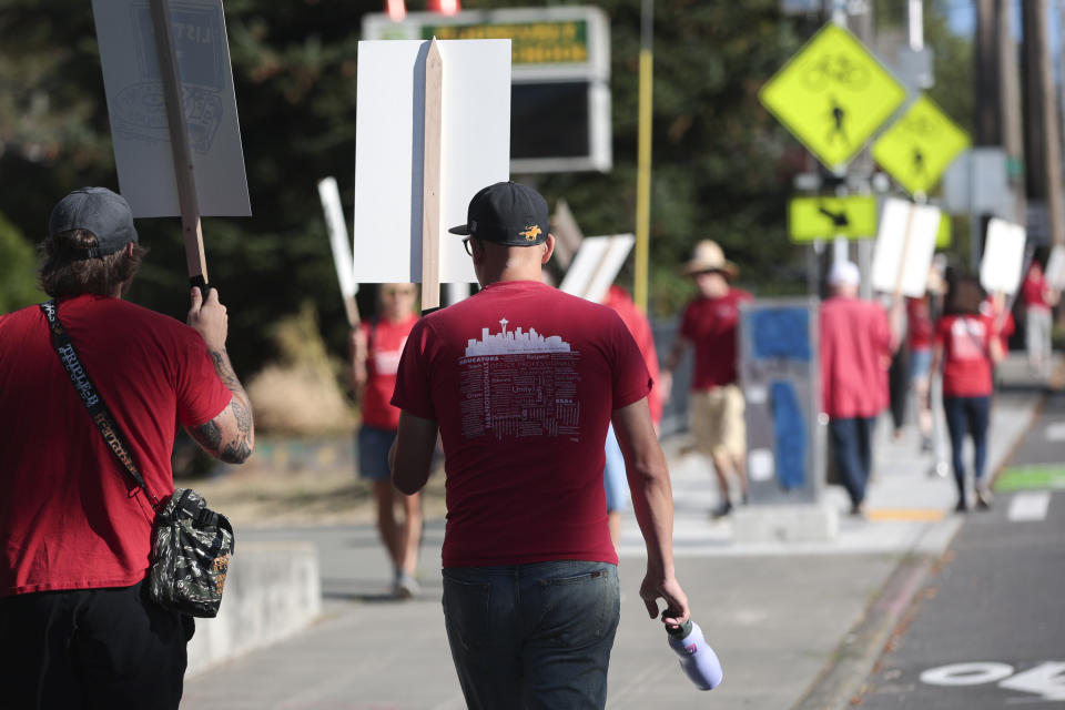 Teachers from Seattle Public Schools picket outside Roosevelt High School on what was supposed to be the first day of classes, Wednesday, Sept. 7, 2022, in Seattle. The first day of classes at Seattle Public Schools was cancelled and teachers are on strike over issues that include pay, mental health support, and staffing ratios for special education and multilingual students. (AP Photo/Jason Redmond)