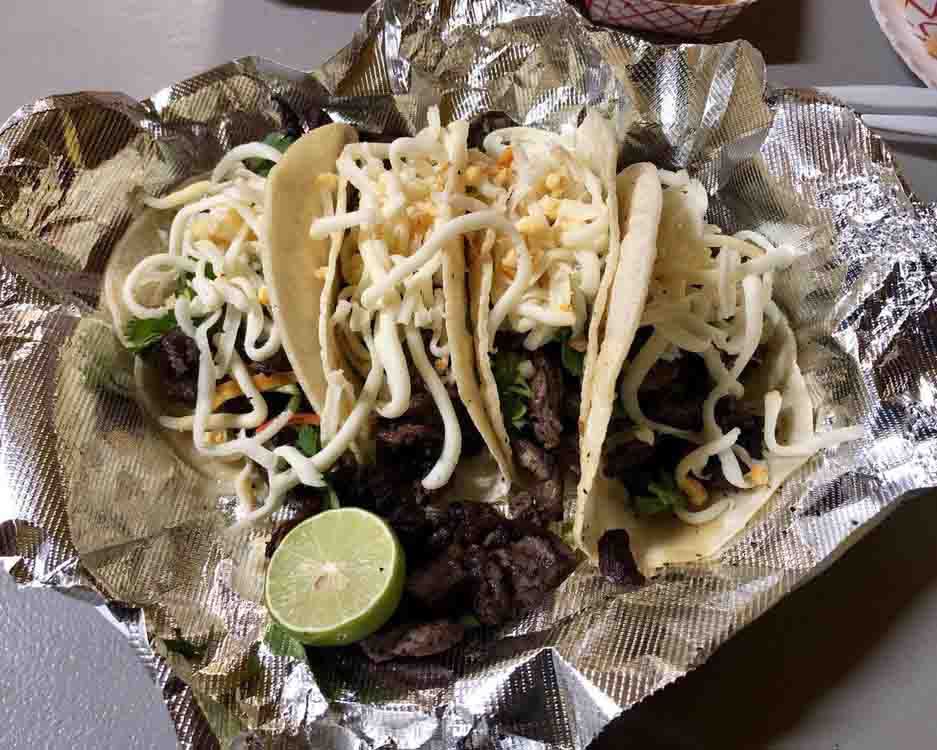 carne asada tacos with cheese and cilantro