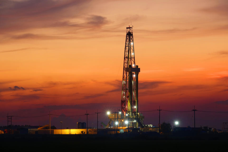 A drilling rig at sunset.