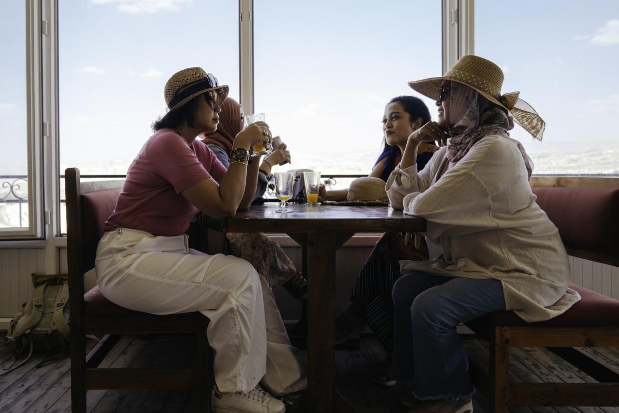 group woman sitting in the restaurant and talking together