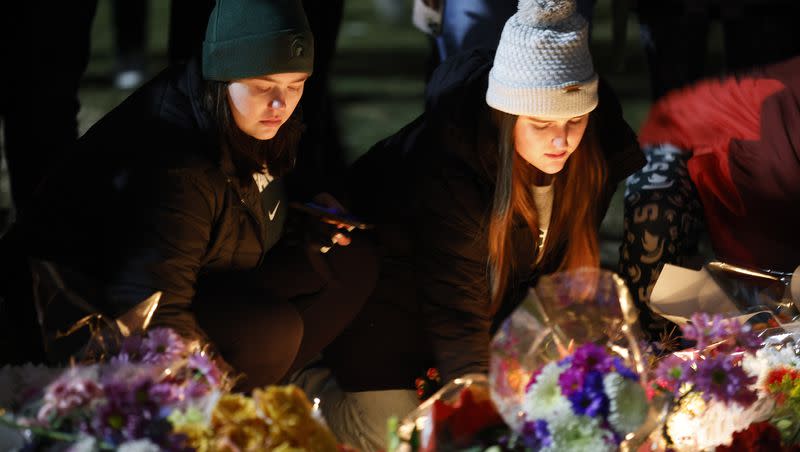 Mourners attend a vigil at The Rock on the grounds of Michigan State University in East Lansing, Mich., on Feb. 15, 2023. A new report is showing a historic annual decrease in murders across the U.S. in 2023.