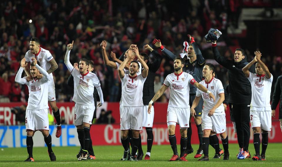 Sevilla's players celebrate at the end of the La Liga soccer match between Real Madrid and Sevilla at the Ramon Sanchez Pizjuan stadium, in Seville, Spain on Sunday, Jan. 15, 2017. Sevilla won 2-1.(AP Photo/Angel Fernandez)