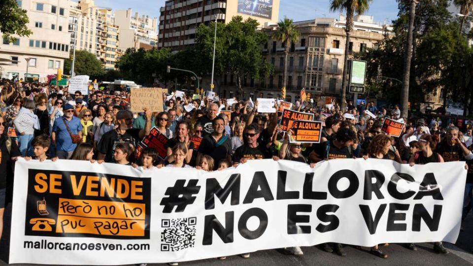 Protesters hold a banner that reads "Mallorca is not for sale" during a protest demonstration against the massification of tourism and housing prices on the island of Mallorca, in Palma de Mallorca 