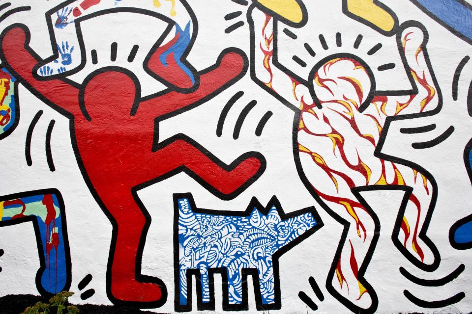 A detail of the newly restored 1987 mural titled "We The Youth" by artist Keith Haring is seen Wednesday, Oct. 30, 2013, in the Point Breeze neighborhood of Philadelphia. The city’s Mural Arts Program has worked for months to restore the only collaborative public mural by Haring that is still intact and at its original site. Haring died of AIDS in 1990 at the age of 31. (AP Photo/Matt Rourke)