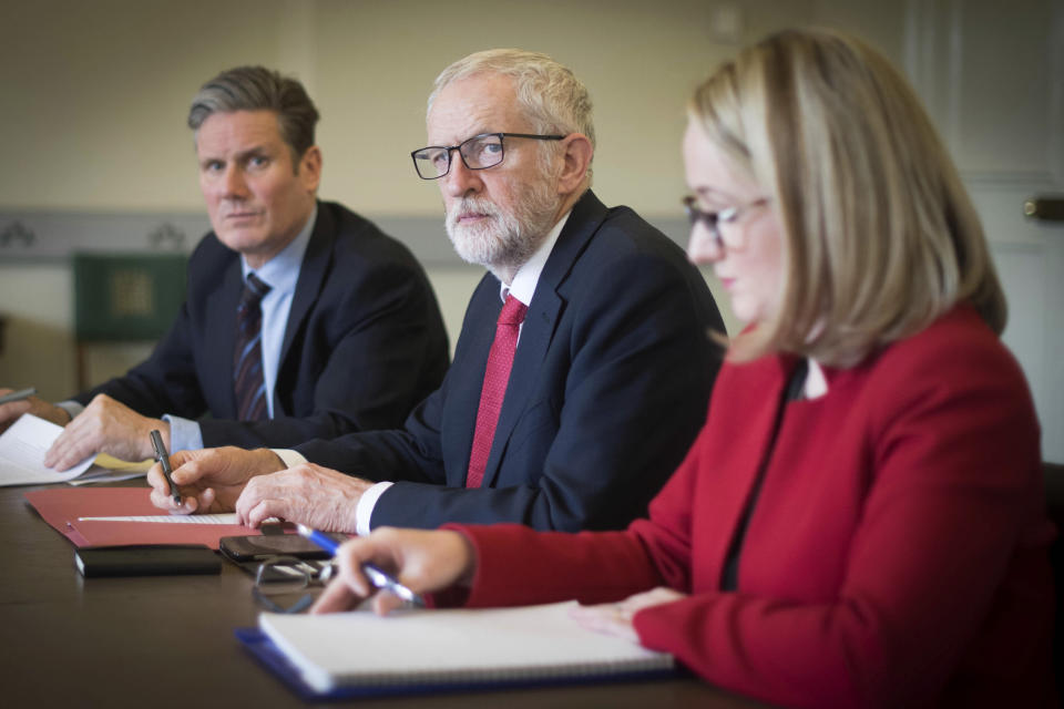 Labour leader Jeremy Corbyn, centre, shadow Brexit secretary Keir Starmer, left and shadow business secretary Rebecca Long-Bailey prepare in his office at the Houses of Parliament in London, Wednesday April 3, 2019,  ahead of a meeting with Britain's Prime Minister Theresa May for talks on ending the impasse over the country's departure from the European Union — a surprise about-face that left pro-Brexit members of May's Conservative Party howling with outrage. (Stefan Rousseau/PA via AP)