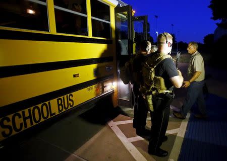 Police officers direct the evacuation of attendees of the Muhammad Art Exhibit and Contest sponsored by the American Freedom Defense Initiative after a shooting outside the Curtis Culwell Center where the event was held in Garland, Texas May 3, 2015. REUTERS/Mike Stone