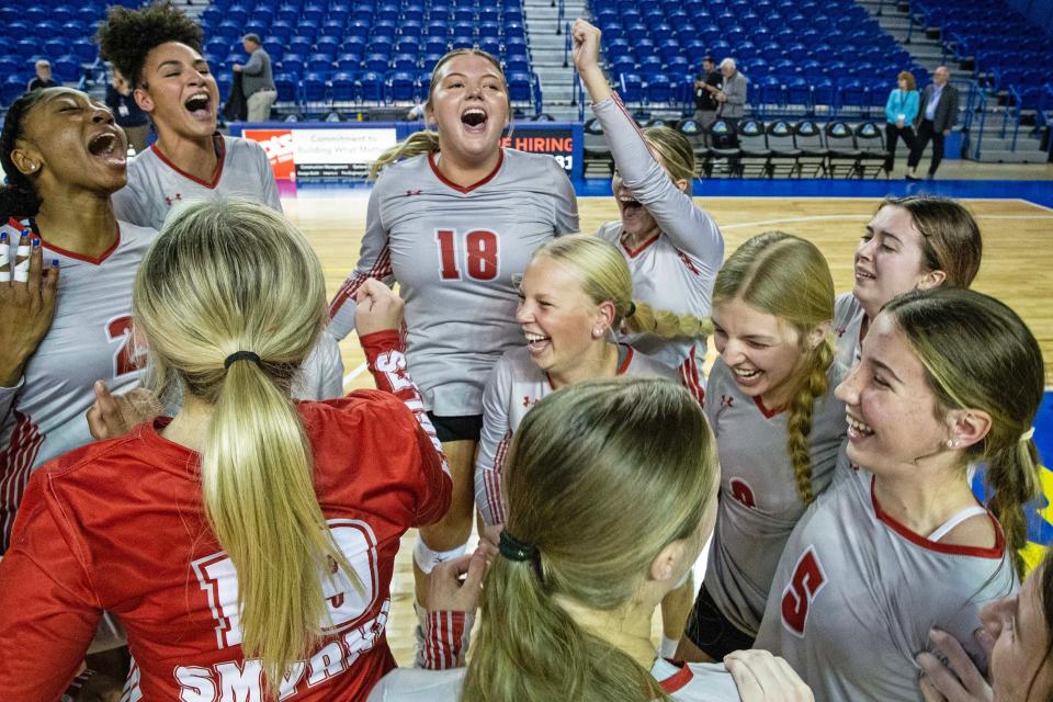 Champions Smyrna High School team members celebrate their 3-1 victory over Ursuline Academy at the conclusion of the DIAA Girls Volleyball Tournament championship game at the Bob Carpenter Center in Newark, Thursday, Nov. 16, 2023.