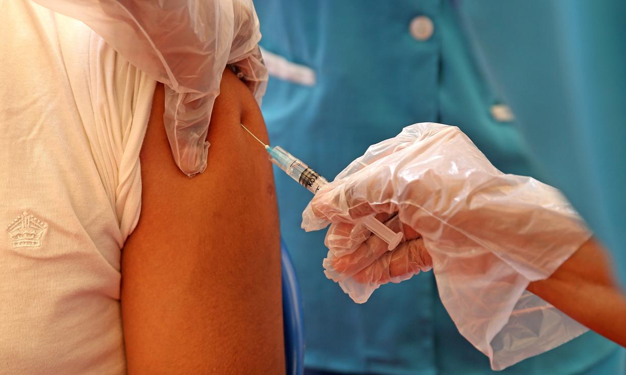 A man receives a shot of a Covid-19 vaccine during an inoculation drive in Bengaluru, India, on 10 June, 2021. (EPA)