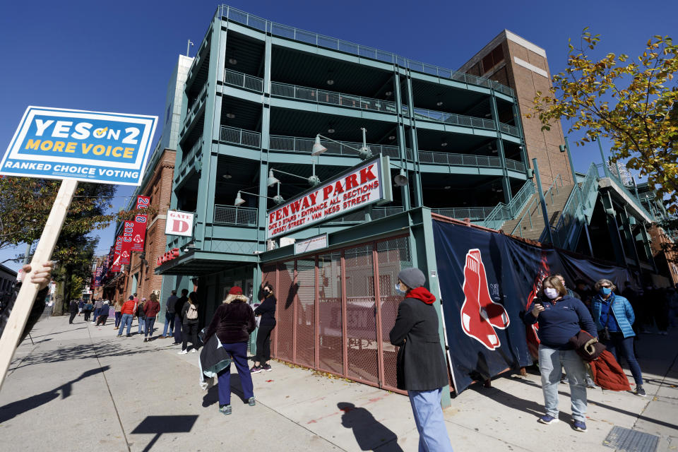 People wait in line to vote at Fenway Park, Saturday, Oct. 17, 2020, in Boston. (AP Photo/Michael Dwyer)