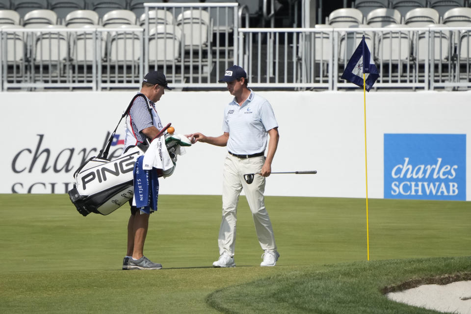 Harris English and his caddie <a class="link " href="https://sports.yahoo.com/ncaaf/players/402474" data-i13n="sec:content-canvas;subsec:anchor_text;elm:context_link" data-ylk="slk:Eric Larson;sec:content-canvas;subsec:anchor_text;elm:context_link;itc:0">Eric Larson</a> on the eight green after he hit a hole-in-one during the second round of the Charles Schwab Challenge golf tournament. Mandatory Credit: Jim Cowsert-USA TODAY Sports