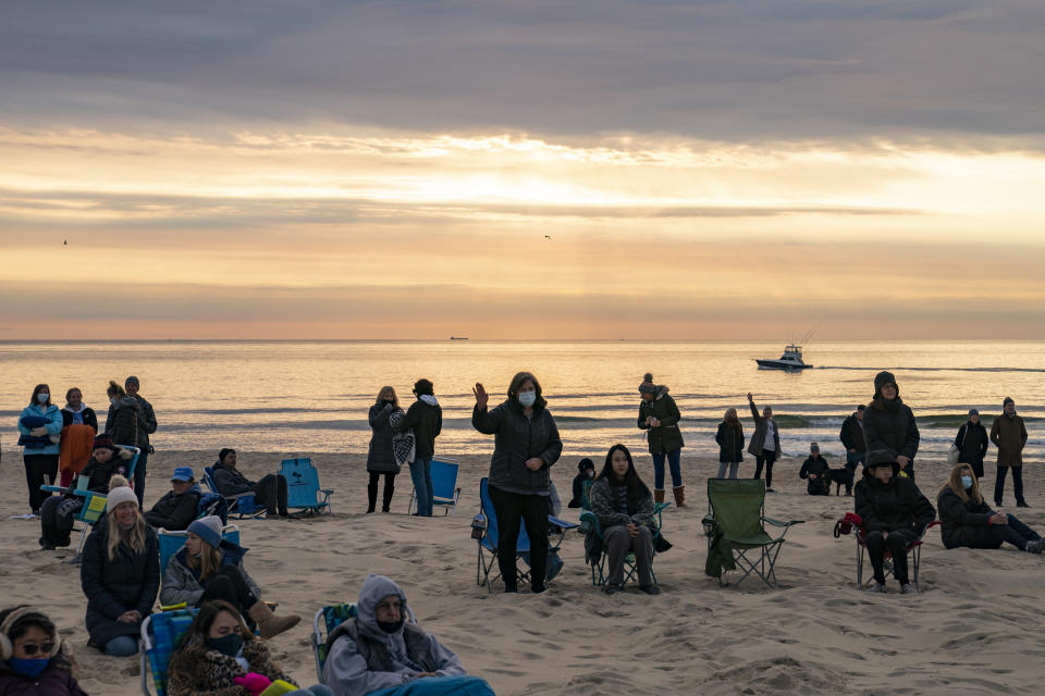 Parishioners gather on a beach for an Easter Sunday service at sunrise hosted by Hope Community Church of Manasquan, Sunday, April 4, 2021, in Manasquan, N.J. (AP Photo/John Minchillo)