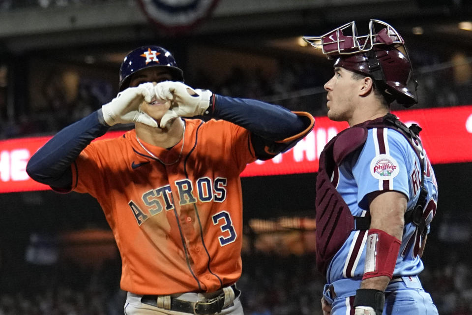 Houston Astros' Jeremy Pena celebrates his home run past Philadelphia Phillies catcher J.T. Realmuto during the fourth inning in Game 5 of baseball's World Series between the Houston Astros and the Philadelphia Phillies on Thursday, Nov. 3, 2022, in Philadelphia. (AP Photo/Matt Slocum)