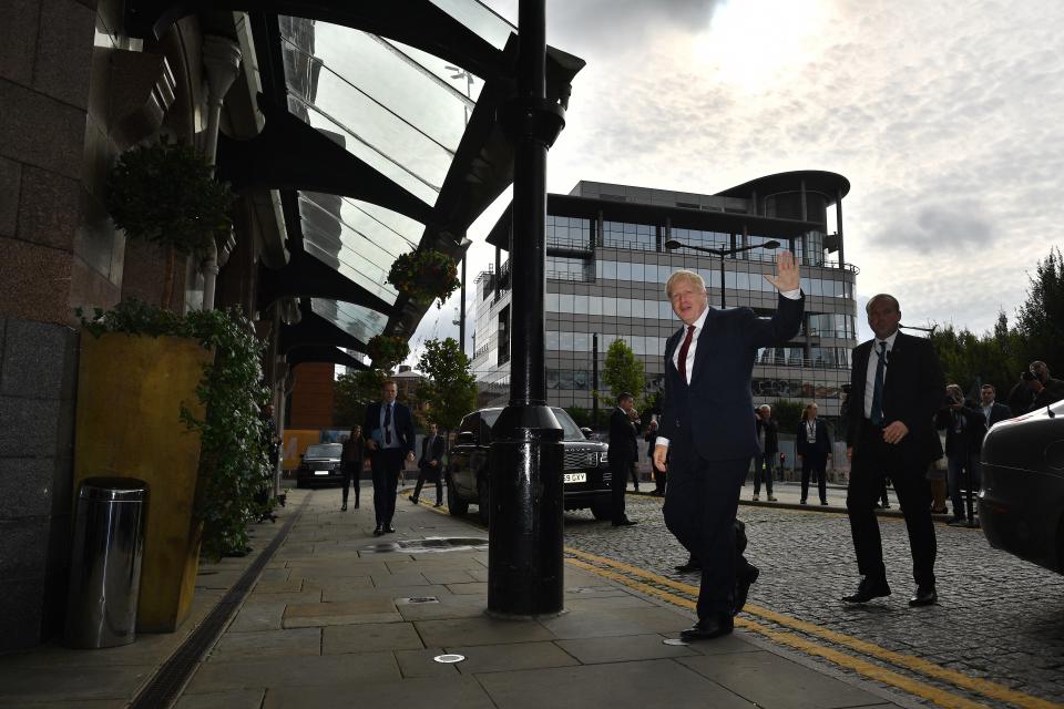 Britain's Prime Minister Boris Johnson waves as he returns to his hotel on the second day of the annual Conservative Party conference in Manchester, north-west England on September 30, 2019. - British Prime Minister Boris Johnson's office has denied allegations he made unwanted sexual advances towards two women 20 years ago. Journalist Charlotte Edwardes wrote in a column for The Sunday Times that Johnson put his hand on her thigh at a dinner party thrown by the magazine he was editing at the time. (Photo by Ben STANSALL / AFP)        (Photo credit should read BEN STANSALL/AFP/Getty Images)