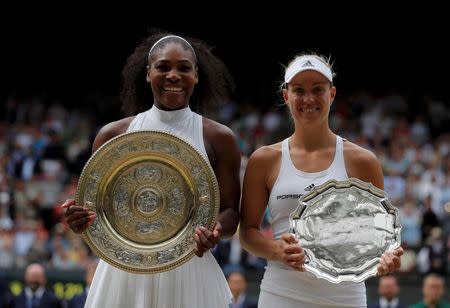 Britain Tennis - Wimbledon - All England Lawn Tennis & Croquet Club, Wimbledon, England - 9/7/16 USA's Serena Williams and Germany's Angelique Kerber hold their respective winner and runner up trophies after Serena Williams won their womens singles final match REUTERS/Andrew Couldridge