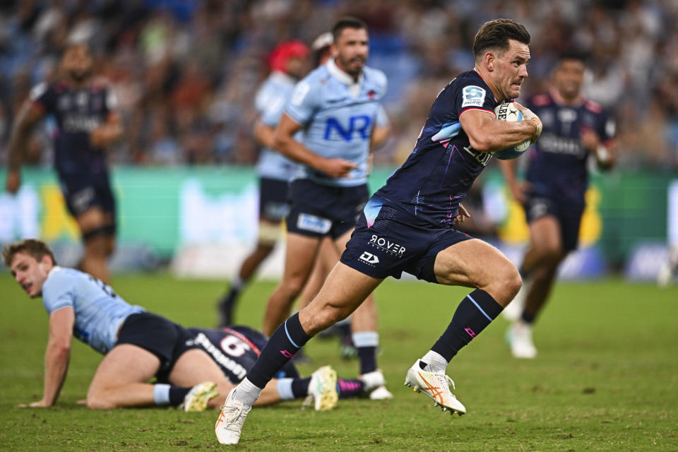 Lachie Anderson of the Rebels runs to score a try during the Super Rugby match between the Waratahs and the Rebels in Sydney, Australia, Friday, March 29, 2024. (James Gourley/AAP via AP)